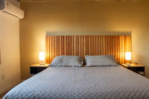 a bedroom with a large bed with two lamps at Alma Serena in La Paloma