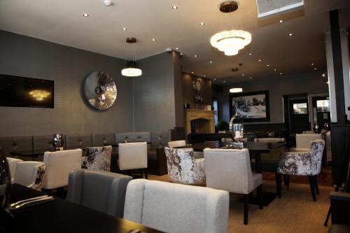 a dining room with tables and chairs and a restaurant at The Eccleston Hotel; BW Signature Collection in Saint Helens