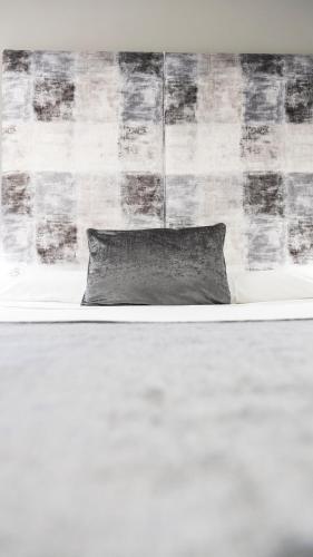 a pillow sitting on top of a bed at Apartamentos Real Lleida in Lleida