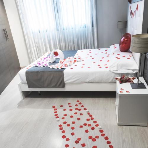 a bedroom with a bed with red hearts on the floor at Apartamentos Real Lleida in Lleida