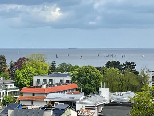 a group of people surfing on the water at Apartament Karlikowska z widokiem na morze in Sopot