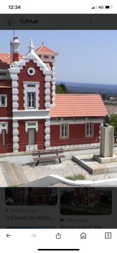a picture of a red building with a website at Apartamento Fazunchar in Figueiró dos Vinhos