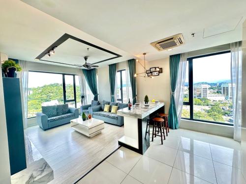 a living room with a table and some chairs at Cozy Living Sky Apartment in Kota Kinabalu
