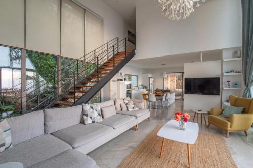 a living room with a couch and a staircase at Villa Ilda - Deluxe Holiday Villa - KALKAN-ANTALYA in Kalkan