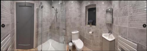 a bathroom with a shower and a toilet and a sink at Ribbleton Rendezvous in Preston in Preston