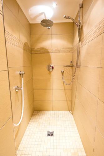 a bathroom with a shower with a glass door at Apart Bergecho in Nauders