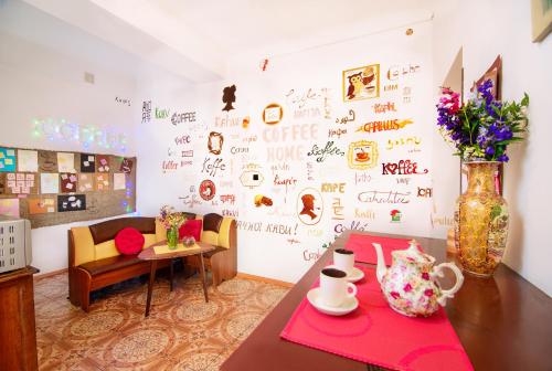 a room with a table and a wall with writing on it at Coffee Home Hostel in Lviv