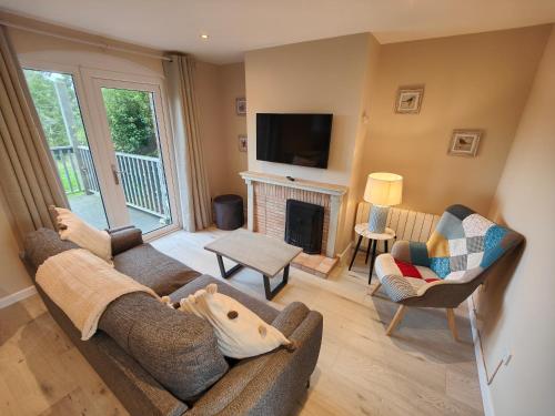a living room with a couch and a fireplace at Moneylands Farm Self-Catering Apartments in Arklow