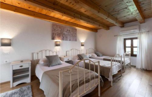 a bedroom with three beds in a room at Residence Panorama in Buzet