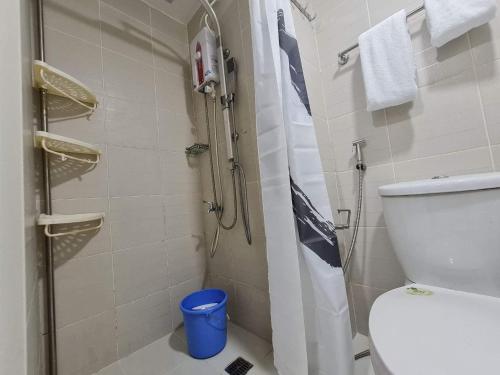 a small bathroom with a shower and a toilet at Rich Staycation Makati in Manila