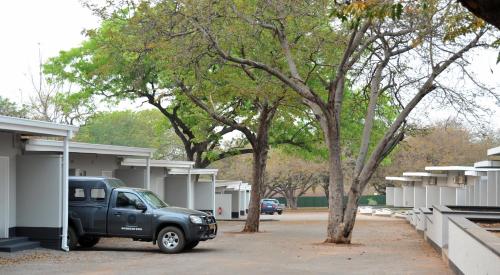 a black truck parked in front of a building at Cresta Sprayview Victoria Falls in Victoria Falls