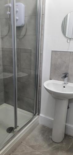 a bathroom with a sink and a shower at Coventry Rise Home in Coventry