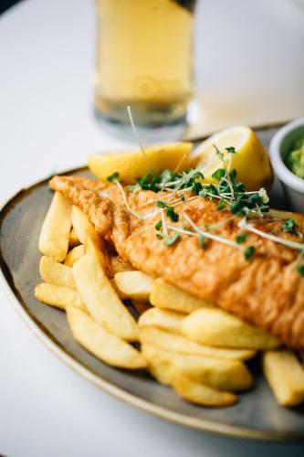 a plate of food with fish and french fries at Holiday Inn Belfast by IHG in Belfast