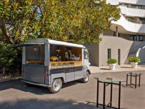 a food truck parked in front of a building at ME Sitges Terramar in Sitges