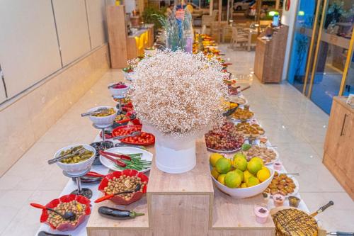 a buffet of food with bowls of fruit and vegetables at Far Life Hotel in Antalya