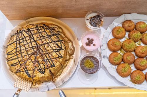 a pie sitting on top of a table with other foods at Far Life Hotel in Antalya