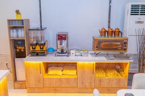 a kitchen with a counter with yellow sheets on it at Far Life Hotel in Antalya