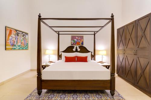 a bedroom with a large bed and two lamps at Lemon Tree Amarante Beach Resort, Goa in Candolim