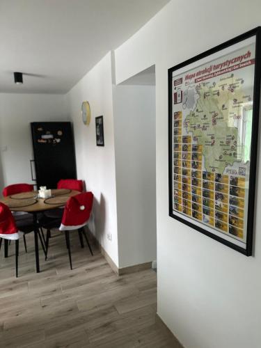 a room with a table and chairs and a map on the wall at Mr. Sowa Sokolec in Ludwikowice Kłodzkie