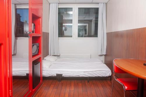 a small room with a bed and a window at Omena Hotel Helsinki City Centre in Helsinki