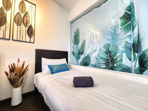 a bedroom with a bed with a large window with plants at Loft Suite City View JB CIQ 7Pax in Johor Bahru