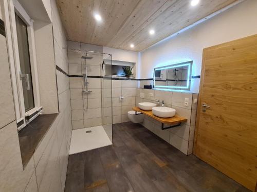 a bathroom with a toilet and a sink and a shower at Haus Stehbock in Partenen