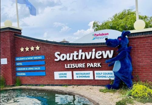 a large blue bear statue standing in front of a sign at Southview Holiday Park, Deluxe Caravan in Skegness