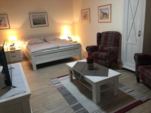 a living room with a bed and a coffee table at Ferienapartments Reitanlage Schenksolz in Schenklengsfeld