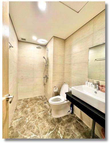 a bathroom with a toilet and a sink at FLC Luxury 2Bedroom Beach Apt Quy Nhon in Quy Nhon