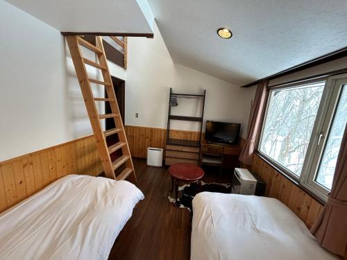 Posteľ alebo postele v izbe v ubytovaní Niseko Pension Bellary