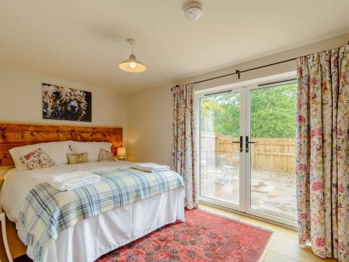 a bedroom with a bed and a sliding glass door at 2 Bed in Beverley 88422 in Lund