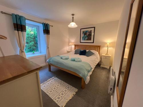 a bedroom with a bed and a window at Bay View Apartment in Tobermory