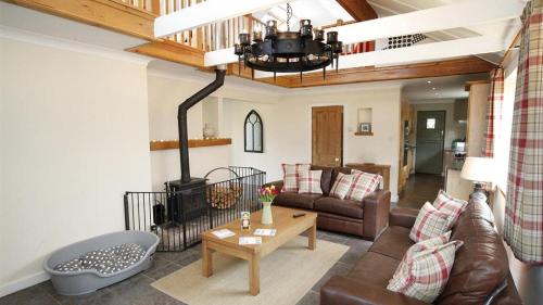 a living room with a couch and a fireplace at Woodside in Parkmill