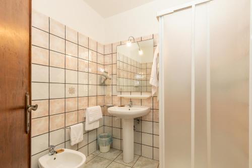 a bathroom with a sink and a toilet at Hotel Pedra Niedda in Budoni