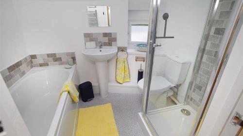 a small bathroom with a toilet and a sink at Bwthyn Bach in The Mumbles