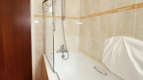 a shower in a bathroom with a bath tub at Caemor in Rhossili