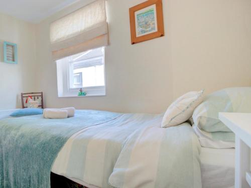 a bedroom with a large bed with a window at 2 Bed in Appledore SALSP in Appledore
