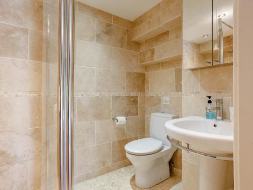 a bathroom with a toilet and a sink at 1 bed in Wedmore 51341 in Chapel Allerton