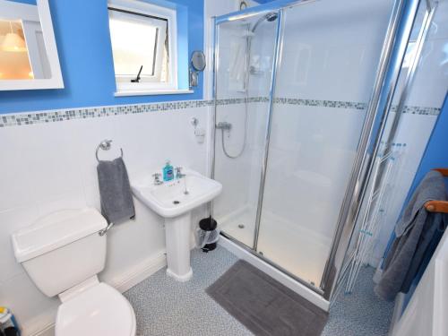 a bathroom with a shower and a toilet and a sink at 1 Bed in Bradwell PK849 in Bradwell