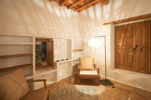 a living room with a chair and a lamp at Ibiza Holliday Villa Harmony in Sant Jordi