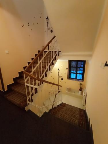 a staircase in a house with birds flying in the air at Penzion Jáchymov Pod Lanovkou in Jáchymov