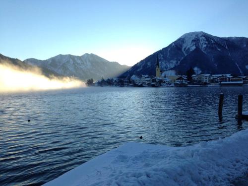 a view of a lake with mountains in the background at Clubhaus Bachmair Weissach in Tegernsee