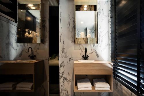 a bathroom with a sink and a mirror at YUP Hotel in Hasselt