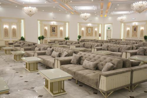 a large waiting room with couches and tables at YM Resort in Yanbu