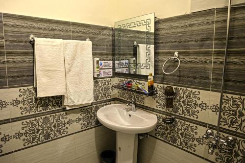 a bathroom with a sink and a mirror at Oak Residency in Gilgit