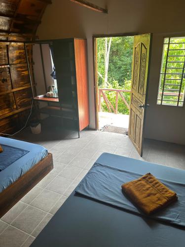 a bedroom with a bed and an open door at Nest Jungle in Kaôh Rŭng (3)