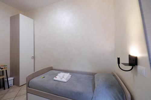 a small bedroom with a bed with two towels on it at Roma Marine House in Lido di Ostia