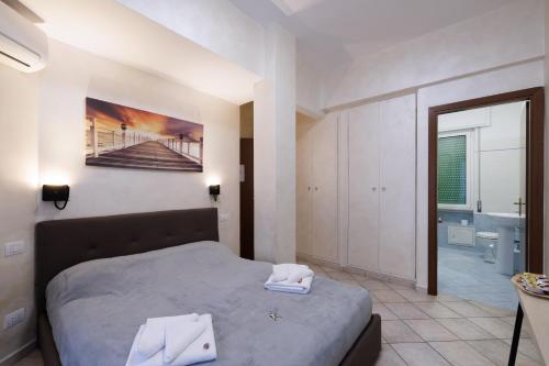 a bedroom with a bed and a bathroom at Roma Marine House in Lido di Ostia
