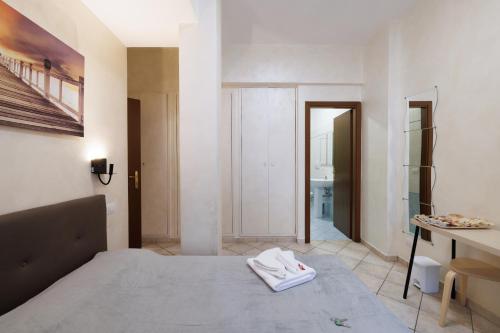 a bedroom with a bed and a hallway with a bathroom at Roma Marine House in Lido di Ostia