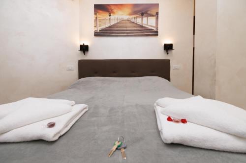 a bedroom with a bed with two toy figures on it at Roma Marine House in Lido di Ostia